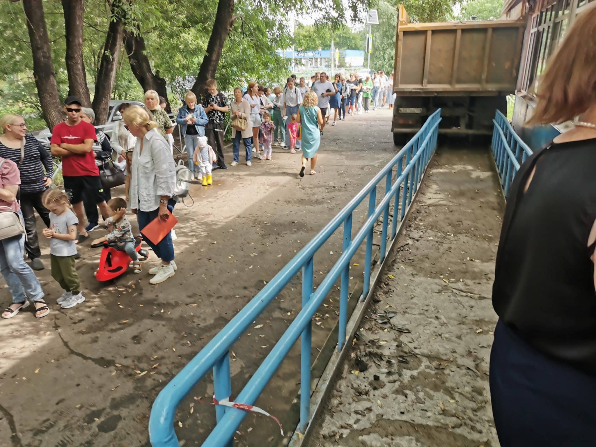 Омичи встали в очередь у затопленной поликлиники на Левобережье, чтобы забрать медкарты детей (видео)